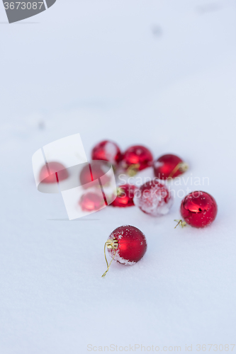 Image of red christmas balls in fresh snow