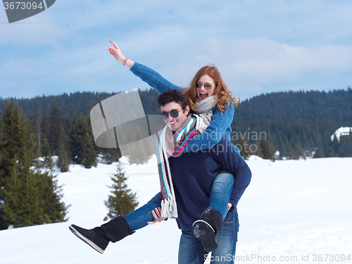 Image of happy young couple having fun on fresh show on winter vacation