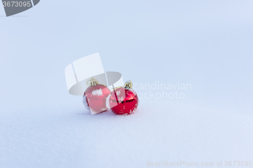 Image of red christmas balls in fresh snow