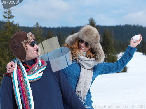 Image of happy young couple having fun on fresh show on winter vacation