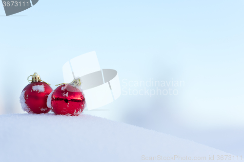 Image of red christmas balls in fresh snow