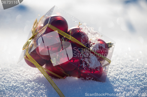 Image of red christmas ball in fresh snow