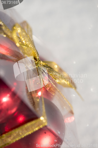 Image of christmas ball in box on fresh  snow