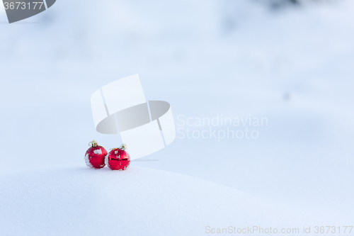 Image of red christmas balls in fresh snow