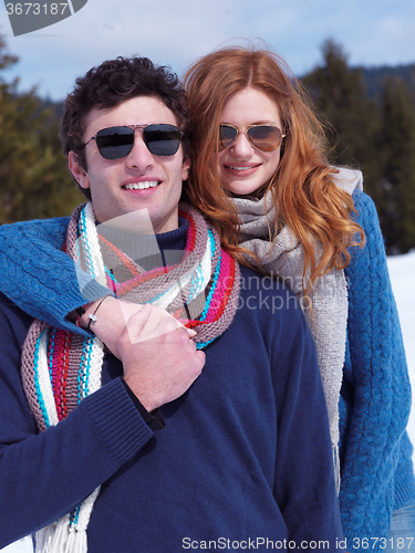 Image of happy young couple having fun on fresh show on winter vacation