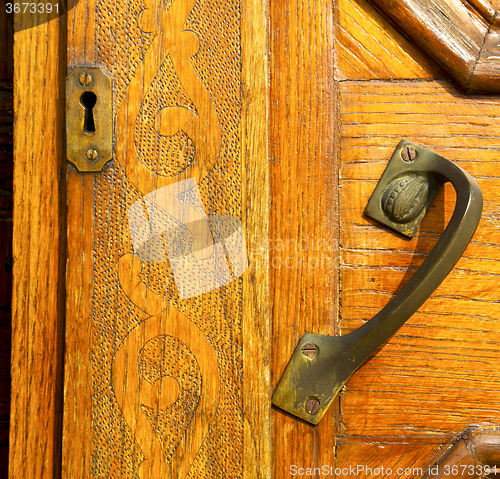 Image of the travedona monate rusty brass brown knocker in a  door  