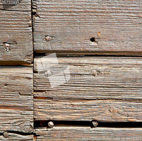 Image of abstract texture of a brown antique wooden old door in italy   e