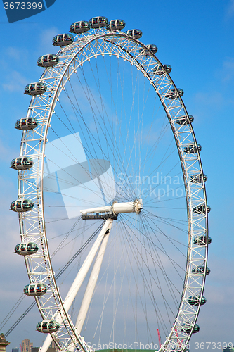 Image of london eye in the  sky and white clouds