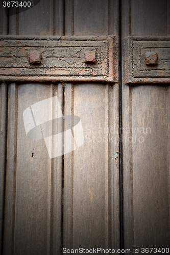 Image of in london antique brown door  rusty  brass nail and light