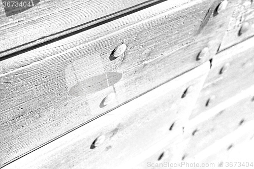 Image of abstract texture of a brown antique wooden old door in italy   e