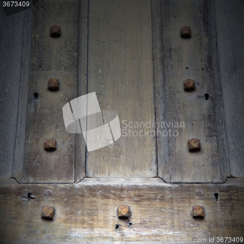 Image of in london antique brown door  rusty  brass nail and light