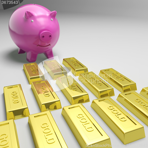 Image of Piggybank Looking At Gold Bars Showing Gold Reserves
