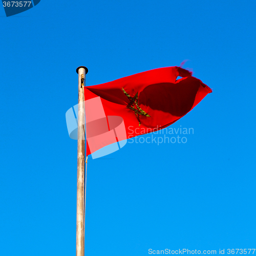 Image of tunisia  waving flag in the blue sky  colour and battlements  wa