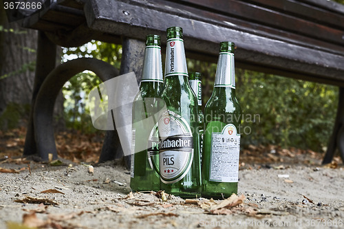 Image of Beer bottles on benches in park