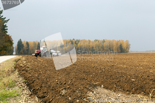 Image of plowed field  by a tractor 