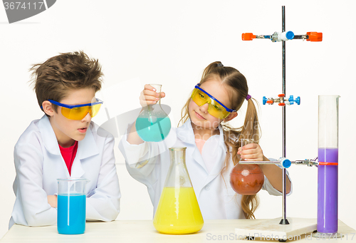 Image of Two cute children at chemistry lesson making experiments