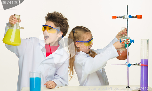 Image of Two cute children at chemistry lesson making experiments