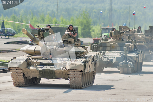 Image of Modernized tank T-72 and convoy in motion. Russia