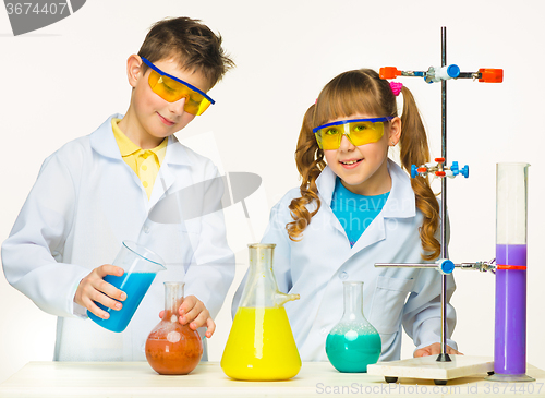 Image of Two cute children at chemistry lesson making experiments