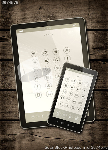 Image of Smartphone and digital tablet PC with desktop icons on a dark wo