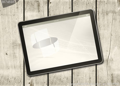 Image of Digital tablet PC on a white wood table