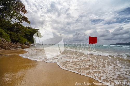 Image of  Secluded beach with a red flag