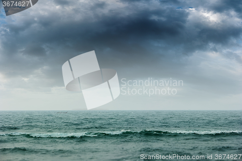 Image of Stormy intense dark clouds over the ocean