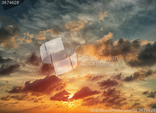 Image of Evening sunset with orange cloud scape.