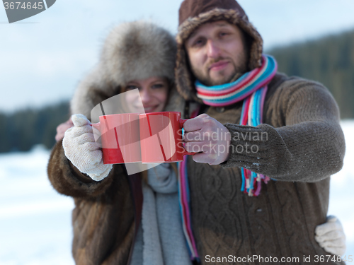 Image of happy young couple drink warm tea at winter