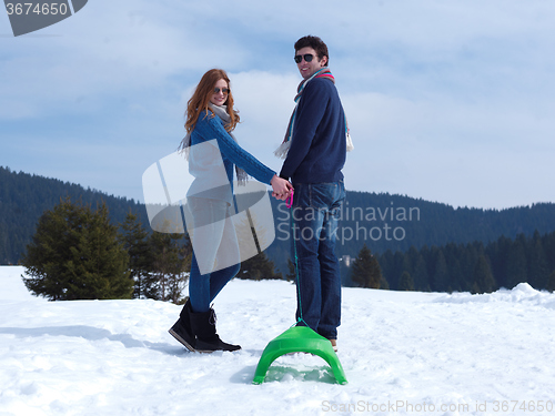 Image of happy young couple having fun on fresh show on winter vacation