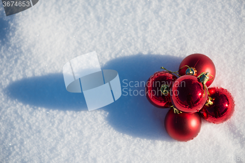 Image of red christmas ball in fresh snow