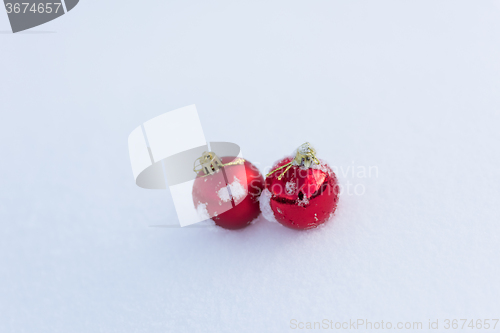 Image of red christmas balls in fresh snow
