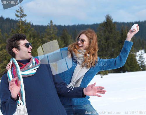 Image of happy young couple having fun on fresh show on winter vacation