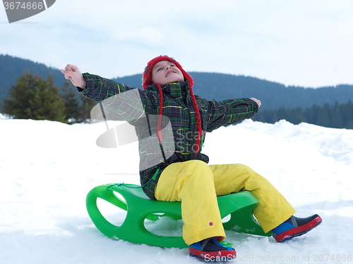 Image of happy young boy have fun on winter vacatioin on fresh snow