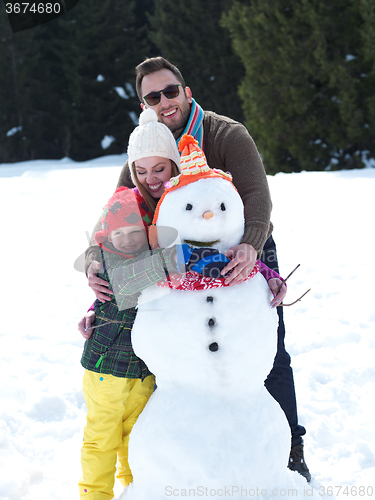 Image of happy family making snowman