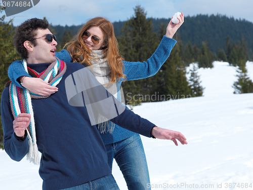 Image of happy young couple having fun on fresh show on winter vacation