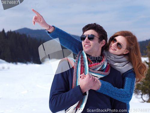 Image of happy young couple having fun on fresh show on winter vacation