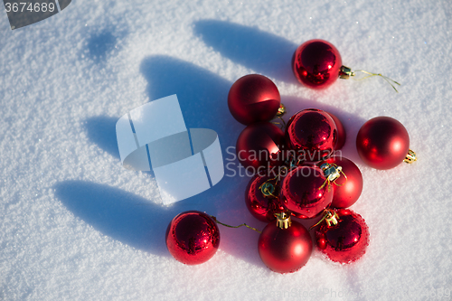 Image of red christmas ball in fresh snow