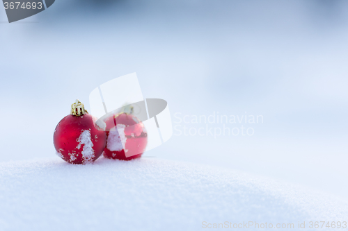 Image of red christmas balls in fresh snow