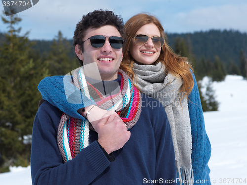 Image of happy young couple having fun on fresh show on winter vacation