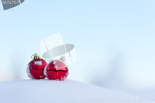 Image of red christmas balls in fresh snow