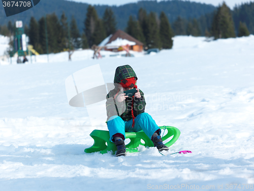 Image of young boy have fun on winter vacatioin and play games on phone