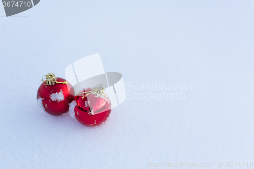 Image of red christmas balls in fresh snow