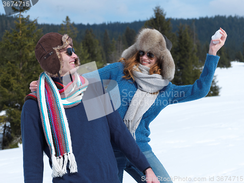 Image of happy young couple having fun on fresh show on winter vacation