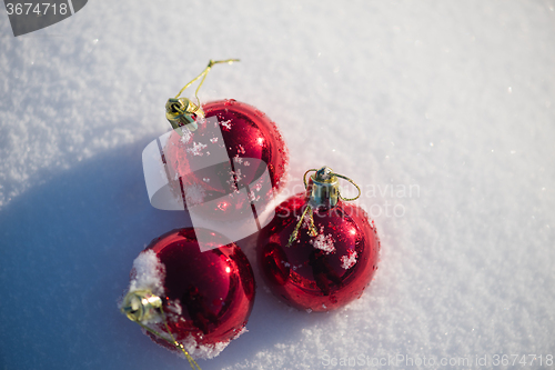 Image of red christmas ball in fresh snow