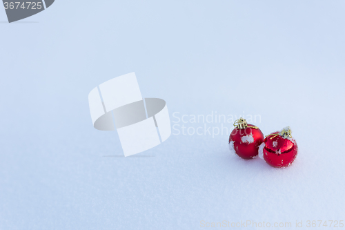 Image of red christmas balls in fresh snow