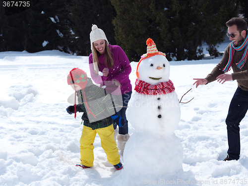 Image of happy family making snowman