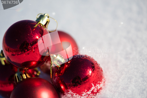 Image of red christmas ball in fresh snow