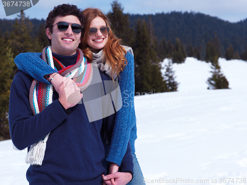 Image of happy young couple having fun on fresh show on winter vacation