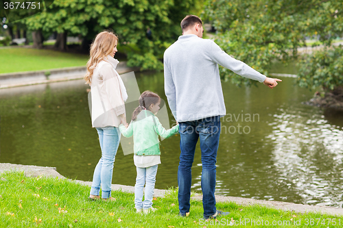 Image of family walking in summer park